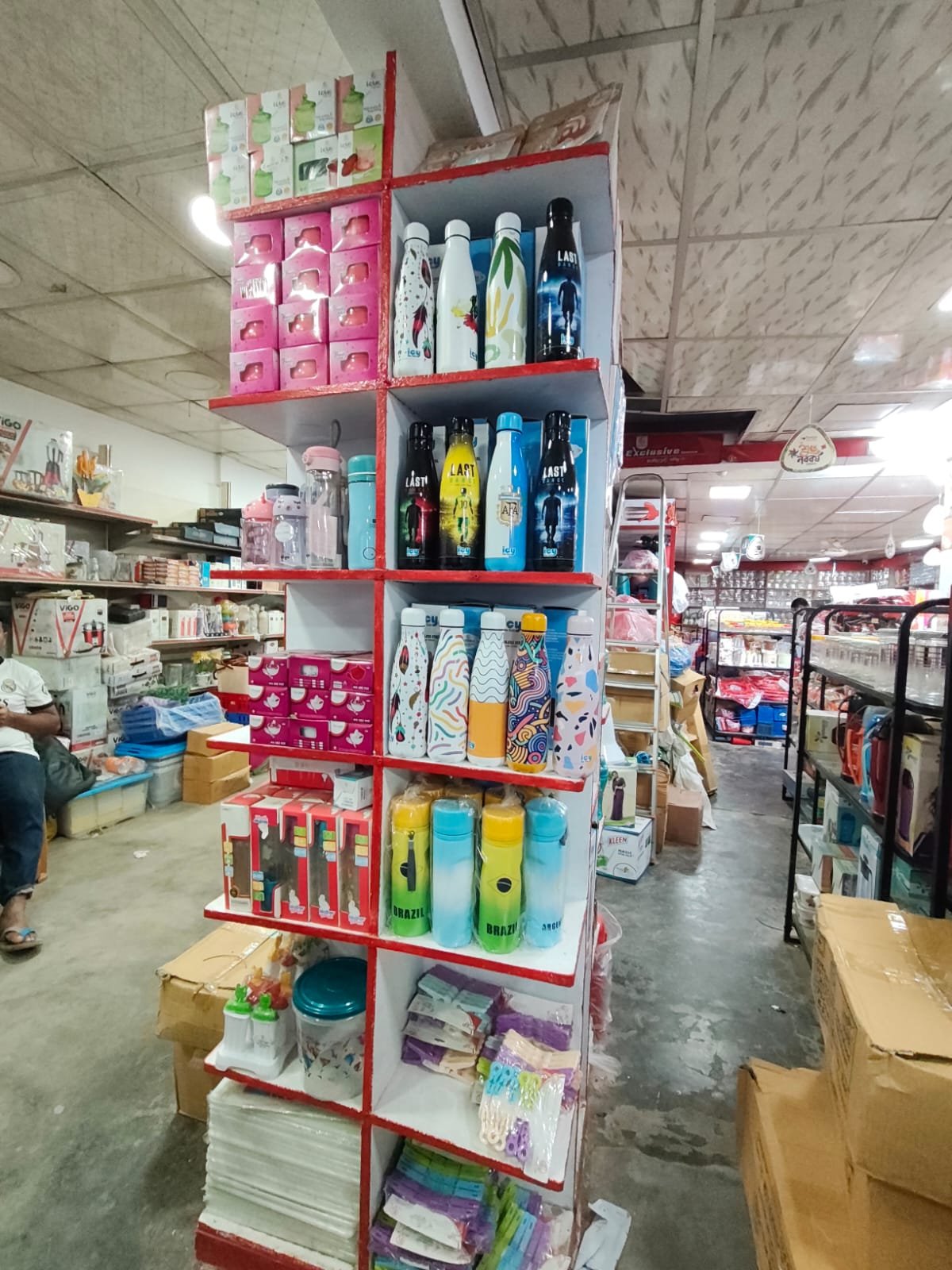 Colourful bottles and drinkware on a showroom display shelf