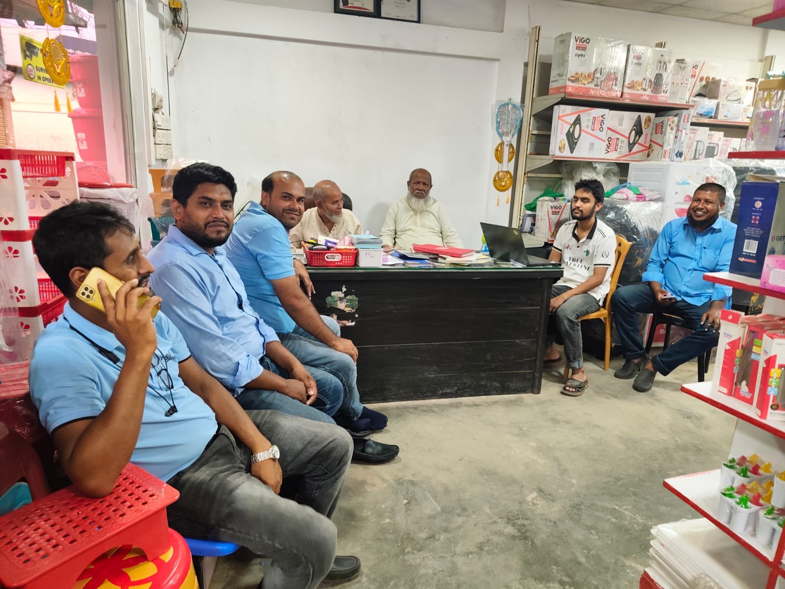 A gathering around the desk inside the showroom