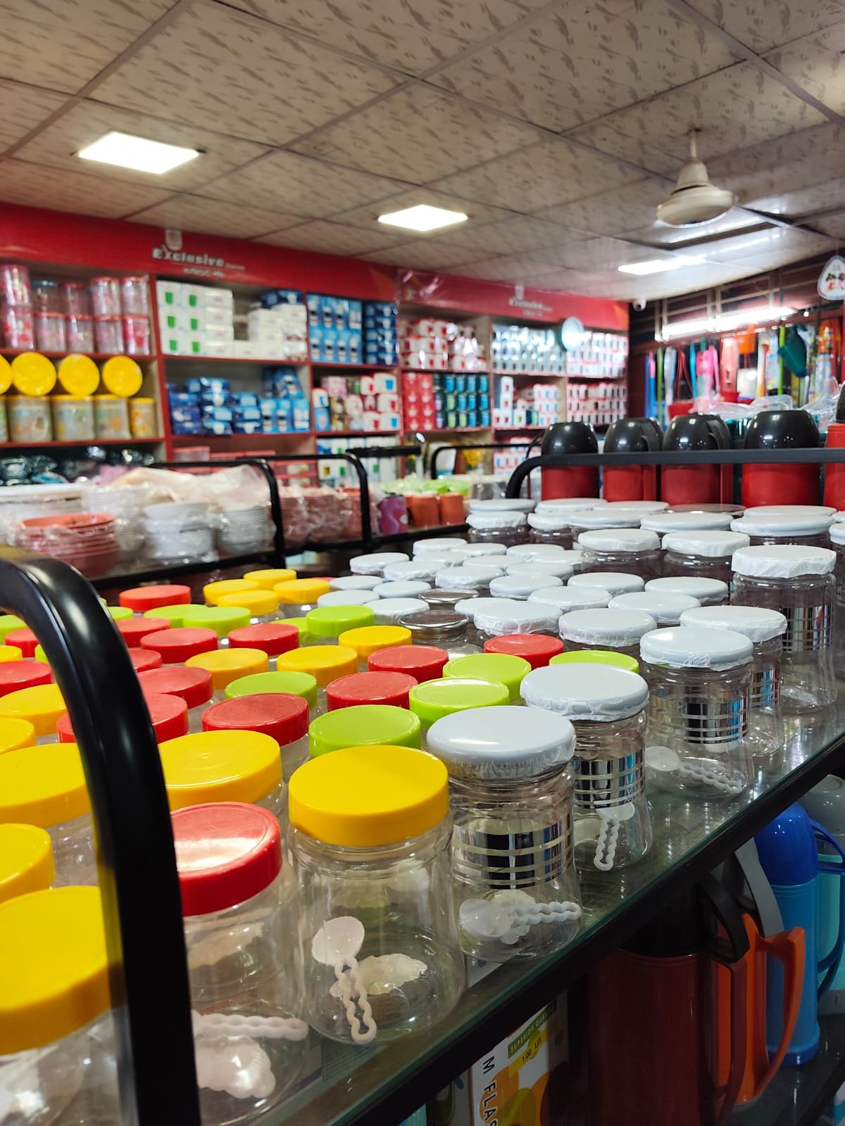 Glass jars with colourful lids displayed inside the showroom